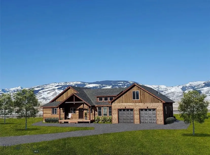 A wood-sided home with a two-bay garage on a green lawn below snow-dusted hills